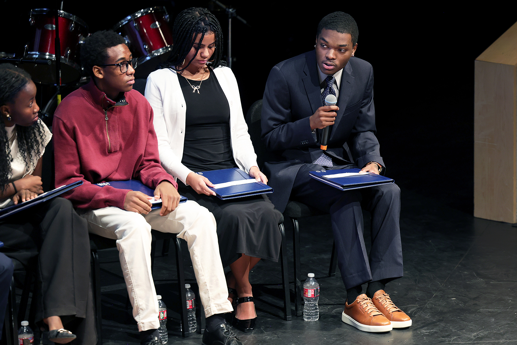 CC junior Ashley Paul '27, far left, listens as another area student asks Yolanda King a question during a 'fireside chat' in front of a packed house in Celeste Theatre. Photo by Jamie Cotten / Colorado College