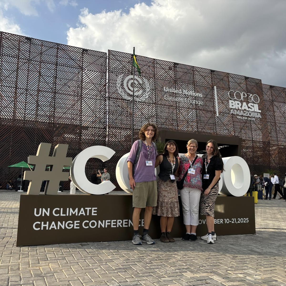 Noah Furuseth ’26, Professor of Anthropology Dr. Sarah Hautzinger, Havalin Haskell ’26, and Riss Banuelos ’26 outside a COP30 venue in November 2025. Photo provided by Banuelos.