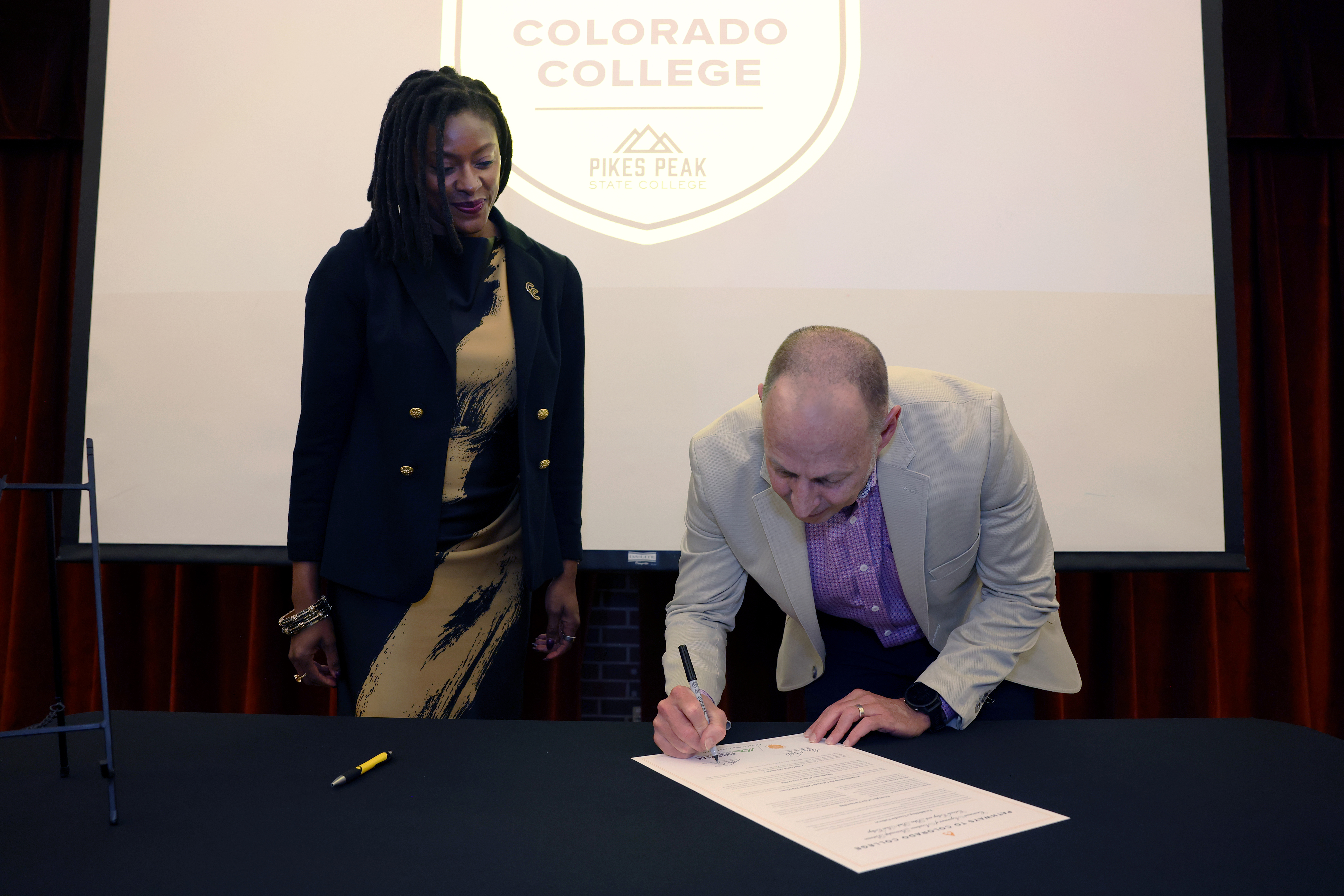 Pikes Peak State College President Lance Bolton signs the transfer pathway articulation agreement on April 30, 2026. Photo by Jamie Cotten / Colorado College