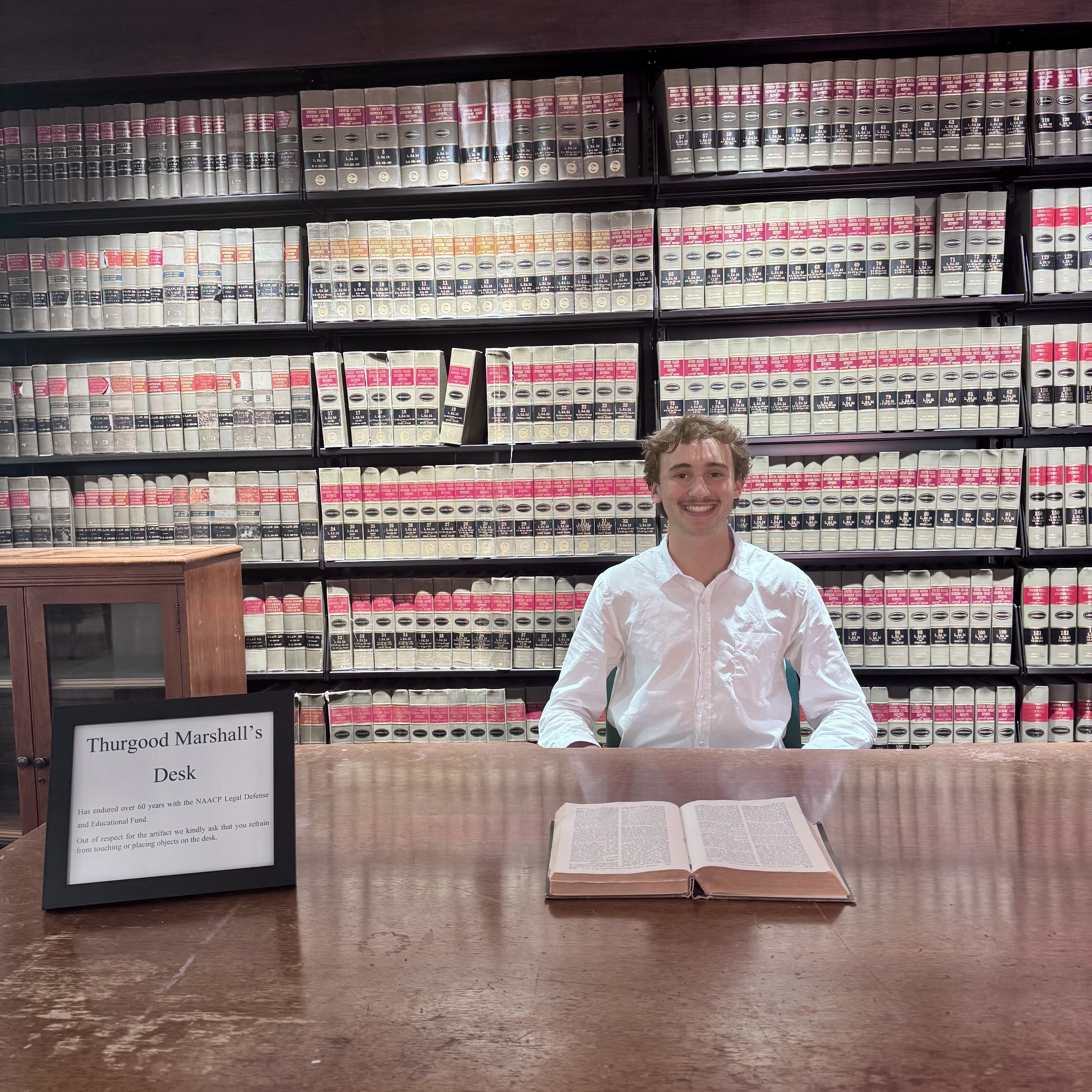 Mack Levy ’27 sitting at Justice Thurgood Marshall's desk. Justice Marshall served as the first Black Supreme Court Justice, founded the NAACP Legal Defense Fund (LDF), and is the namesake of the Thurgood Marshall Institute (TMI). Photo provided by Levy.