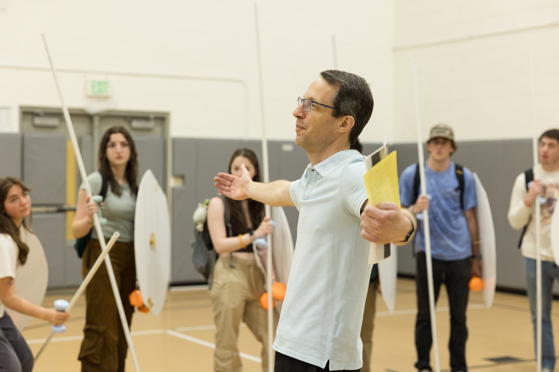 Associate Professor and Chair of Classics Dr. Richard Fernando Buxton used creative ways to teach the material, including bringing students to the Fitness Center to use equipment to simulate what it was like to wield ancient Roman and Greek armor. This was a class from 2024. Photo by Eileen Broderick.
