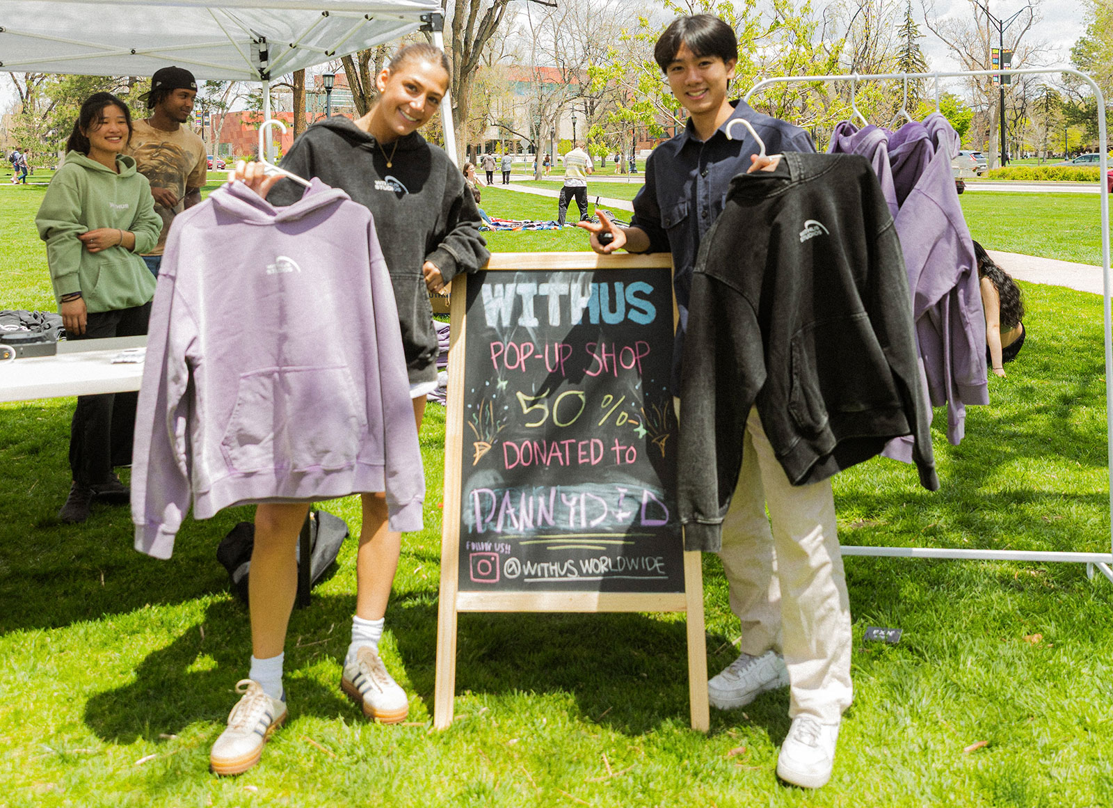CC students Lydia Vassallo ’27 and Hyungyu Kim '27 at a pop up sale for WITHUS outside Worner Campus Center on May 9, 2025. Photo provided by Kim.